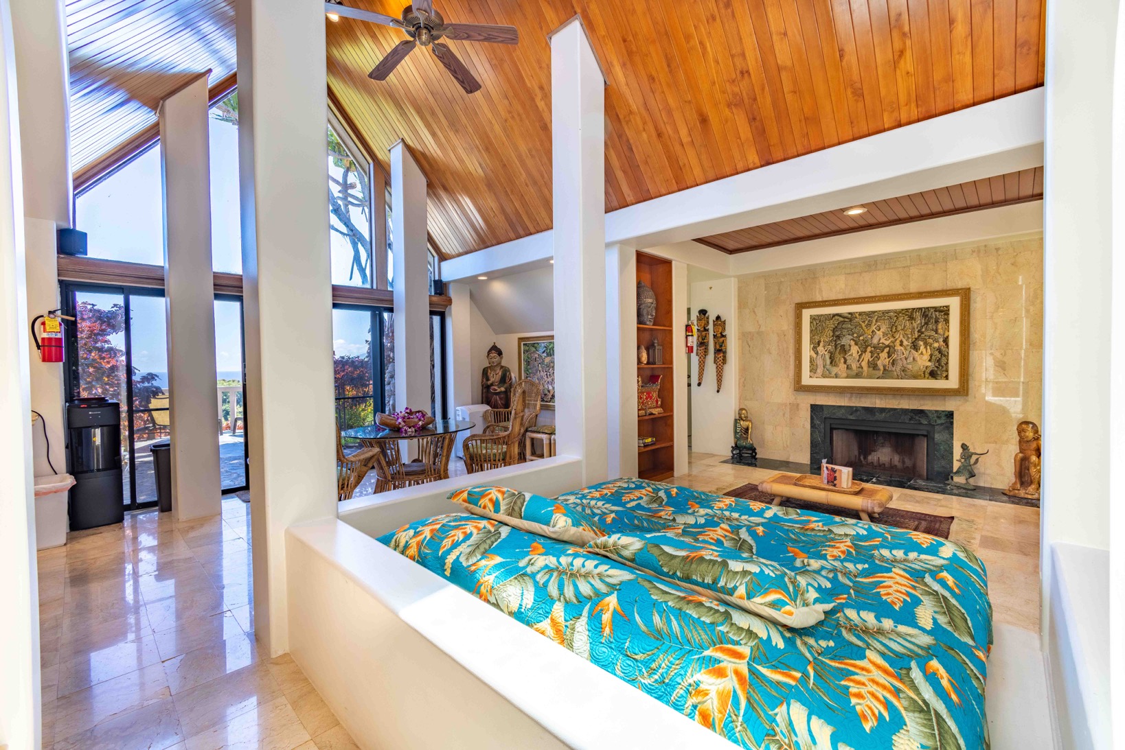 Cliff House: Close-up of sofa bed under skylight and fire place in background