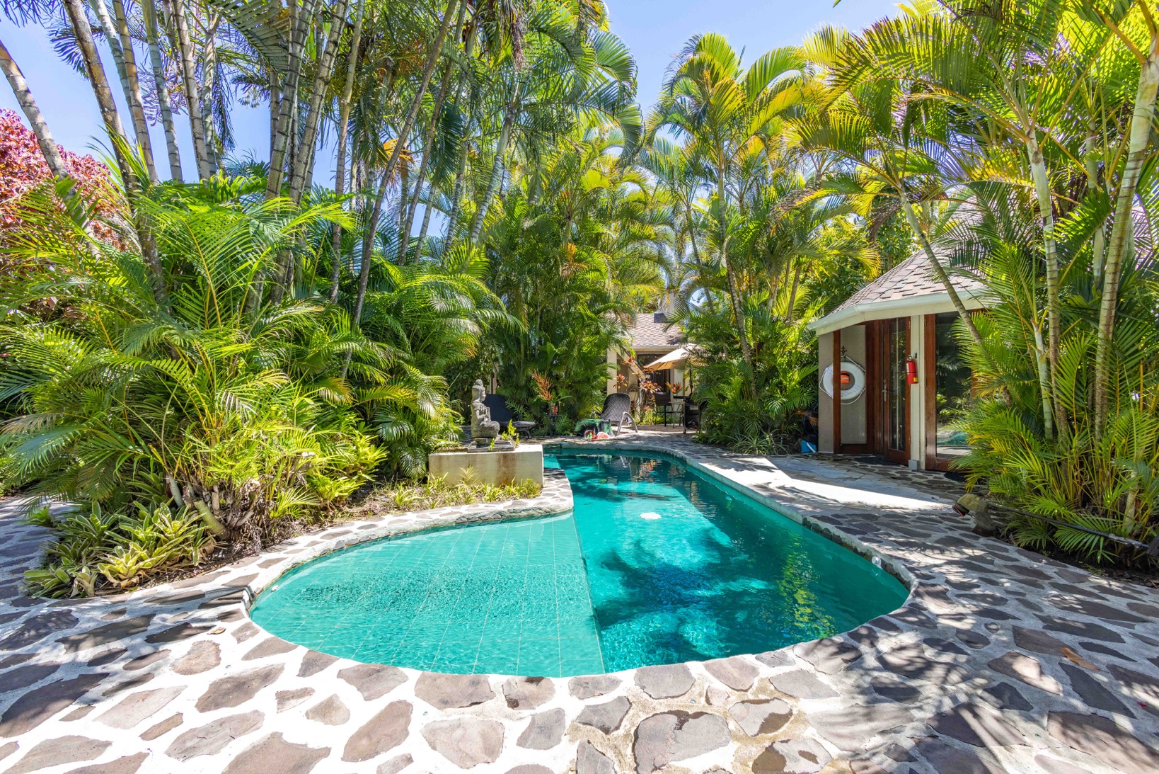 Cliff House: Private emerald-tiled pool and gazebo house covered by lush Hawaiian foliage