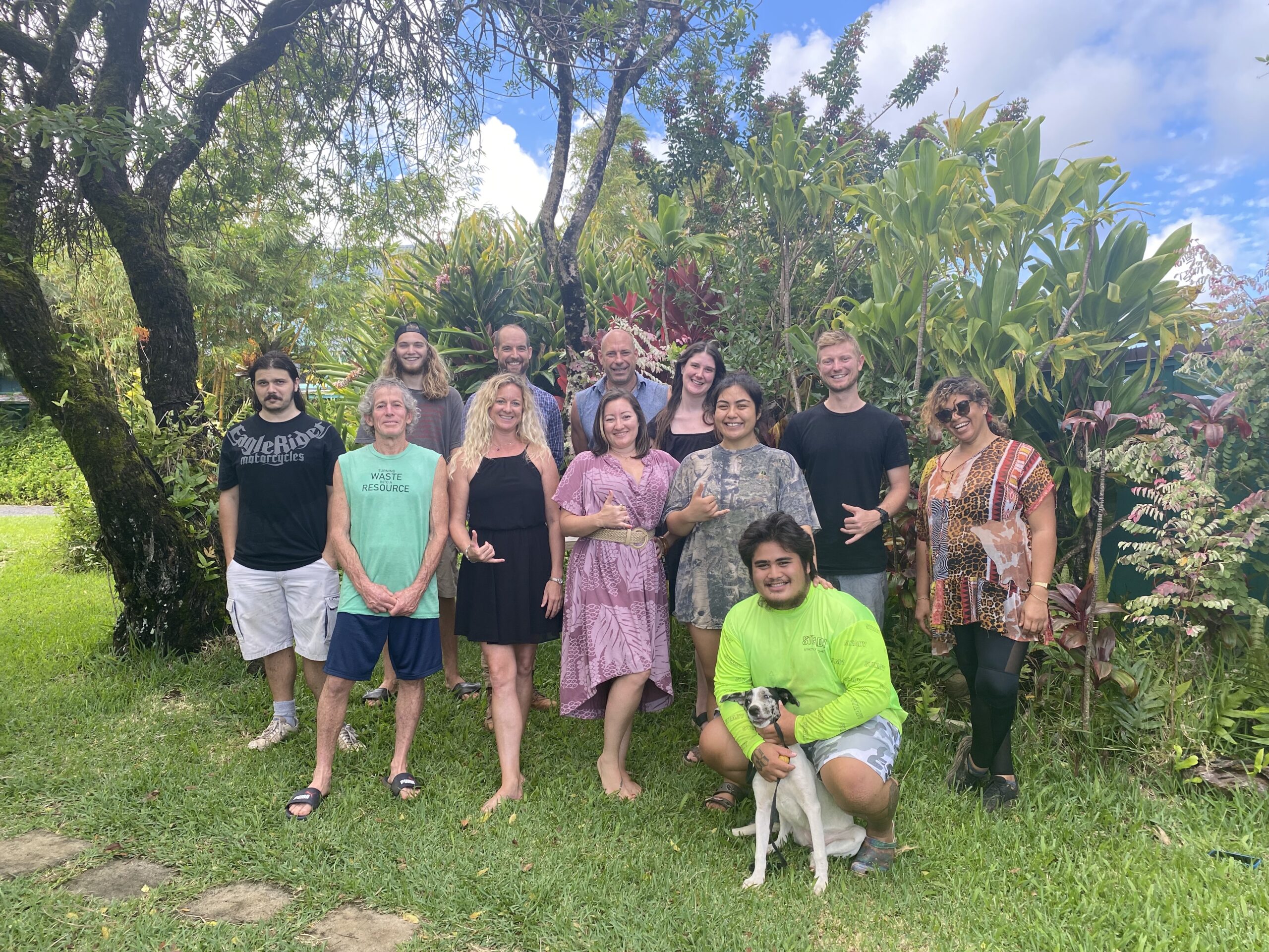 Maui Eco Retreat Center Hale Akua's staff posing for group shot in the garden with trees in background